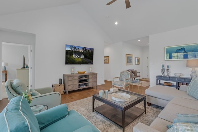 living room featuring ceiling fan, high vaulted ceiling, and light hardwood / wood-style floors