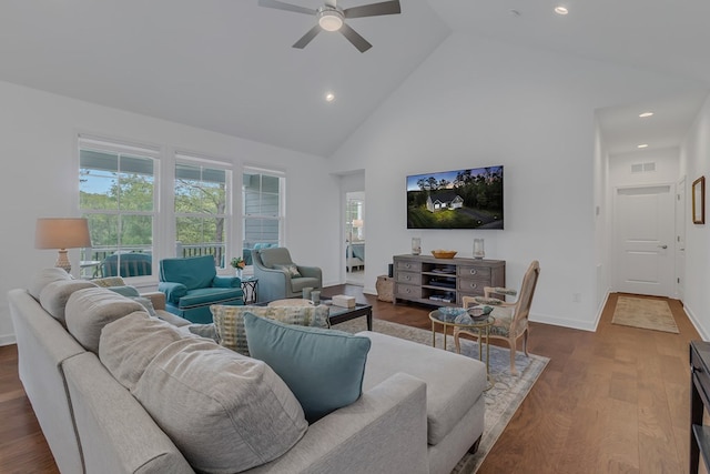 living room with ceiling fan, plenty of natural light, dark hardwood / wood-style floors, and high vaulted ceiling