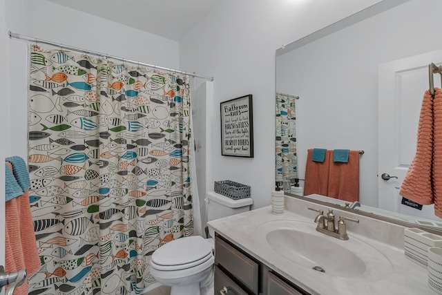 bathroom with vanity, curtained shower, and toilet