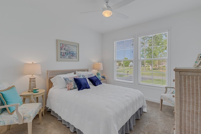 bedroom featuring light colored carpet and ceiling fan