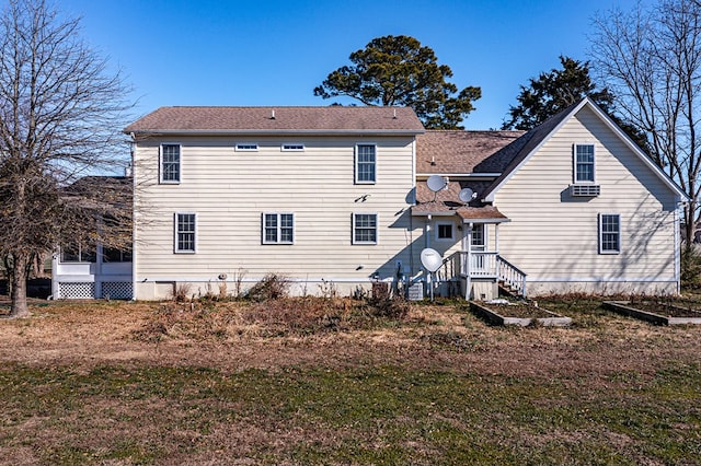 back of property featuring a lawn