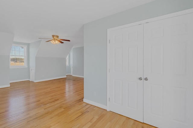 bonus room featuring light hardwood / wood-style floors, ceiling fan, and lofted ceiling