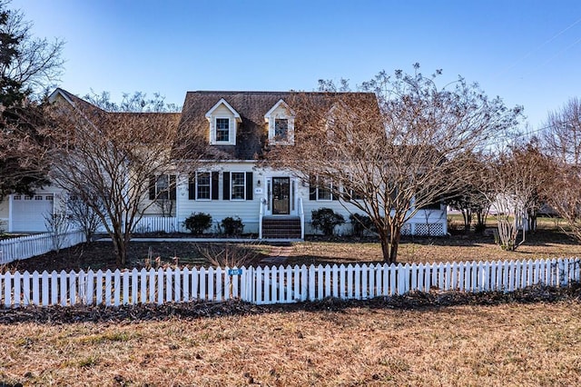 cape cod-style house featuring a fenced front yard and entry steps