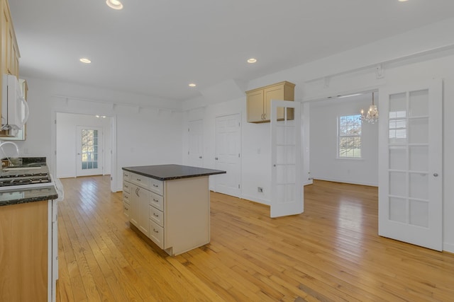 kitchen featuring a kitchen island, light wood-type flooring, and a wealth of natural light