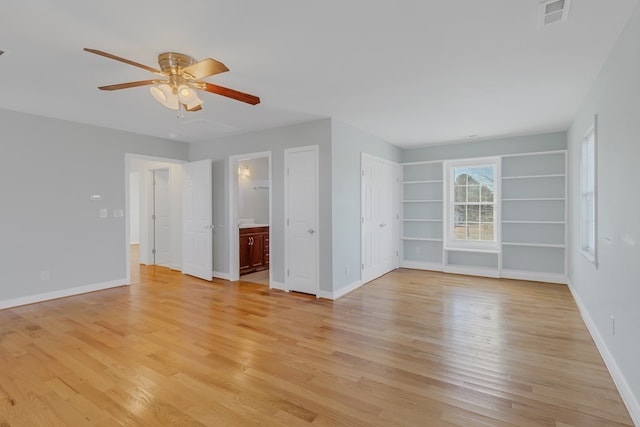 empty room with ceiling fan and light wood-type flooring