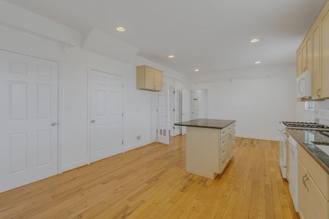 kitchen with recessed lighting, light wood-style flooring, a kitchen island, white appliances, and baseboards