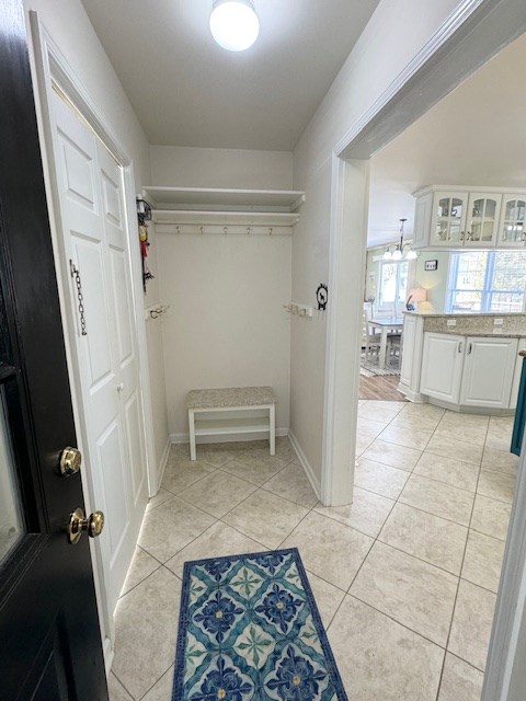 mudroom with baseboards and light tile patterned floors