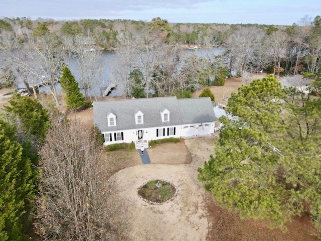 birds eye view of property featuring a view of trees