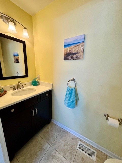 bathroom with tile patterned floors, baseboards, visible vents, and vanity