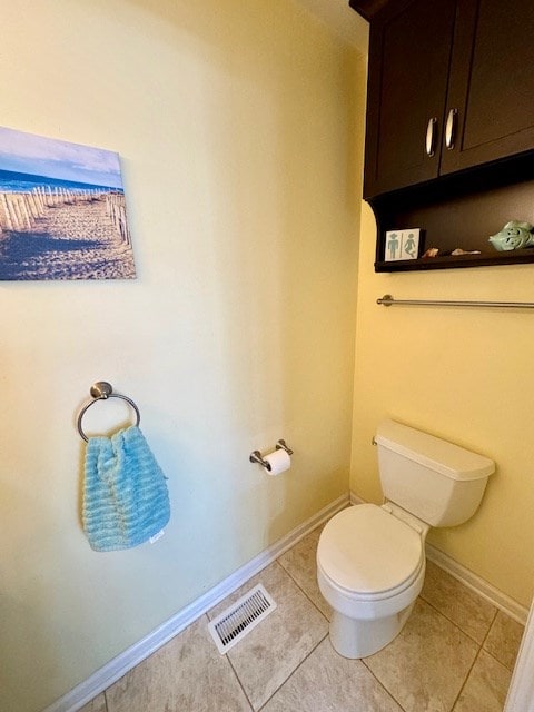 bathroom with tile patterned flooring, baseboards, visible vents, and toilet