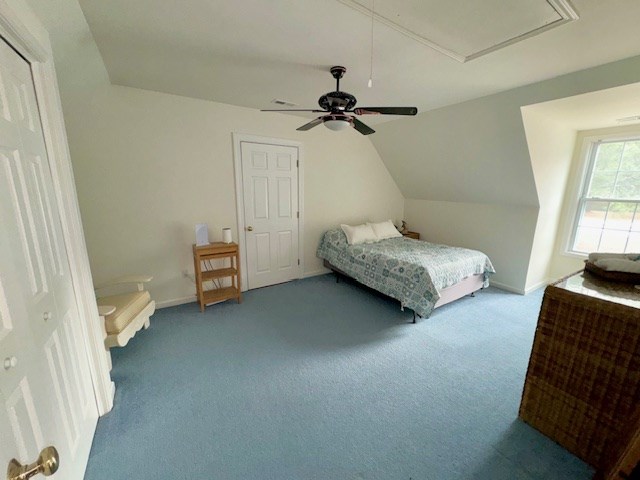 carpeted bedroom featuring lofted ceiling, ceiling fan, and baseboards