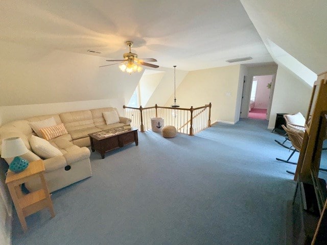 living room with a ceiling fan, lofted ceiling, visible vents, and carpet floors