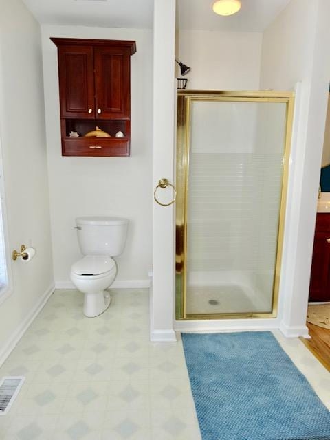 bathroom featuring toilet, a stall shower, baseboards, and visible vents