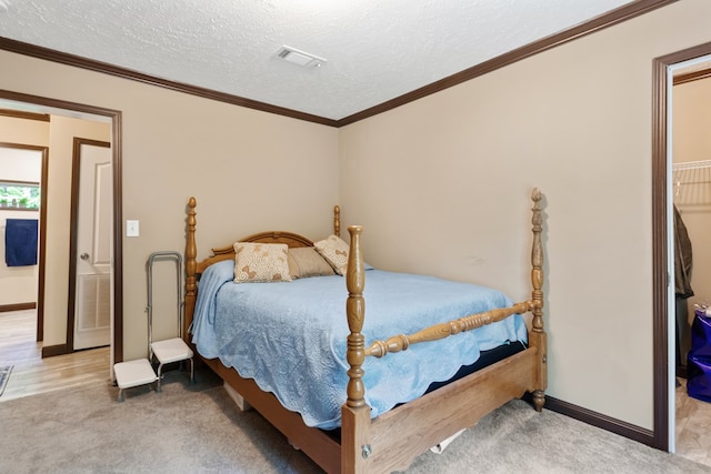 bedroom featuring a textured ceiling, visible vents, light carpet, and baseboards
