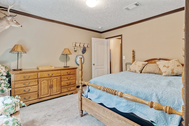 bedroom with crown molding, light colored carpet, a textured ceiling, and visible vents