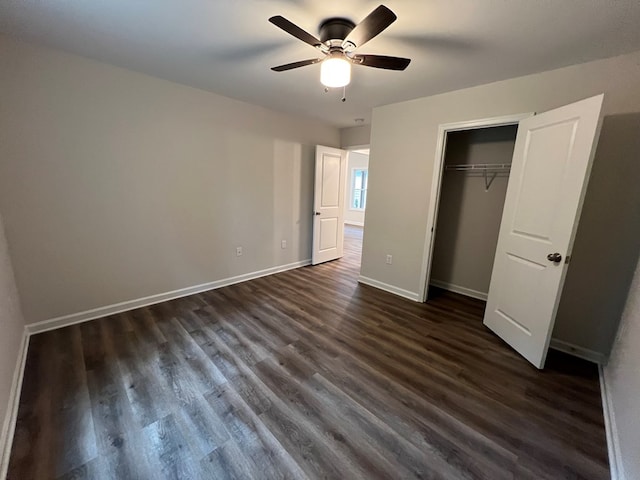 605 Shorewood Dr, Colonial Beach, VA 22443 - unfurnished bedroom with dark wood-type flooring, baseboards, a ceiling fan, and a closet