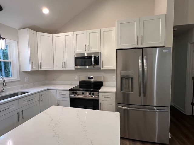 605 Shorewood Dr, Colonial Beach, VA 22443 - kitchen featuring appliances with stainless steel finishes, a sink, lofted ceiling, white cabinetry, and dark wood-type flooring
