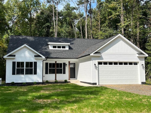 605 Shorewood Dr, Colonial Beach, VA 22443 - view of front facade featuring a shingled roof, driveway, a front yard, and a garage