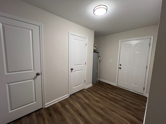 605 Shorewood Dr, Colonial Beach, VA 22443 - foyer featuring dark wood finished floors, baseboards, and water heater