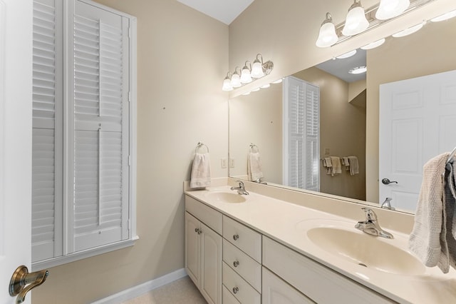 341 Pine Reach Dr, Kilmarnock, VA 22482 - bathroom featuring double vanity, a sink, and baseboards