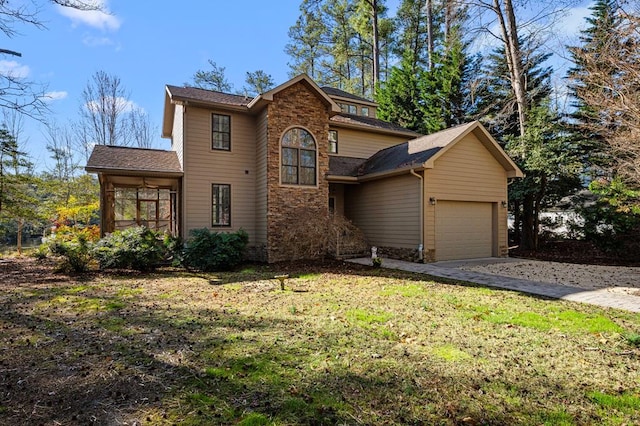 341 Pine Reach Dr, Kilmarnock, VA 22482 - traditional home featuring driveway, stone siding, an attached garage, a front lawn, and a sunroom