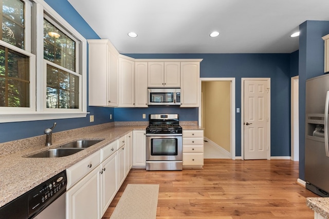 341 Pine Reach Dr, Kilmarnock, VA 22482 - kitchen with a sink, light stone countertops, light wood-style flooring, and appliances with stainless steel finishes