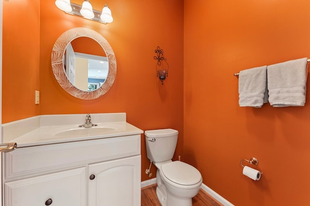 341 Pine Reach Dr, Kilmarnock, VA 22482 - bathroom with toilet, vanity, baseboards, and wood finished floors