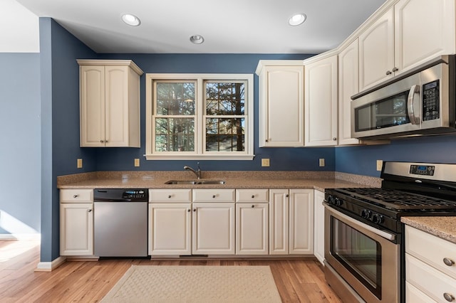 341 Pine Reach Dr, Kilmarnock, VA 22482 - kitchen featuring recessed lighting, baseboards, a sink, light wood-style flooring, and appliances with stainless steel finishes