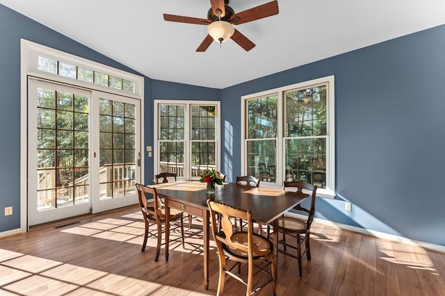 341 Pine Reach Dr, Kilmarnock, VA 22482 - dining area with vaulted ceiling, wood-type flooring, baseboards, visible vents, and ceiling fan