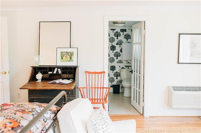 interior space with ornamental molding, baseboards, and a wall mounted air conditioner