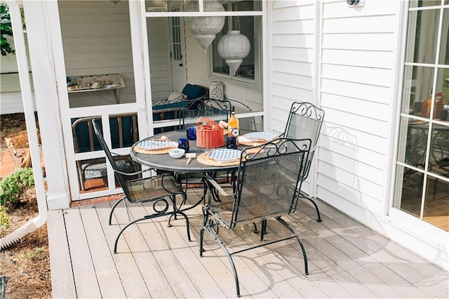 exterior space featuring outdoor dining space and a deck