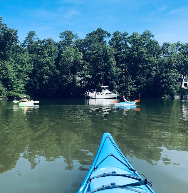 dock area featuring a water view and a wooded view