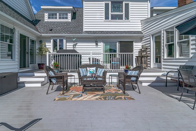 view of patio featuring a wooden deck and an outdoor living space