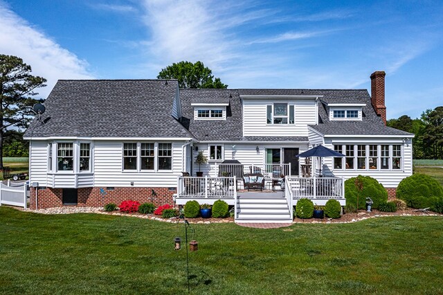 rear view of property with a deck, a chimney, a shingled roof, crawl space, and a yard