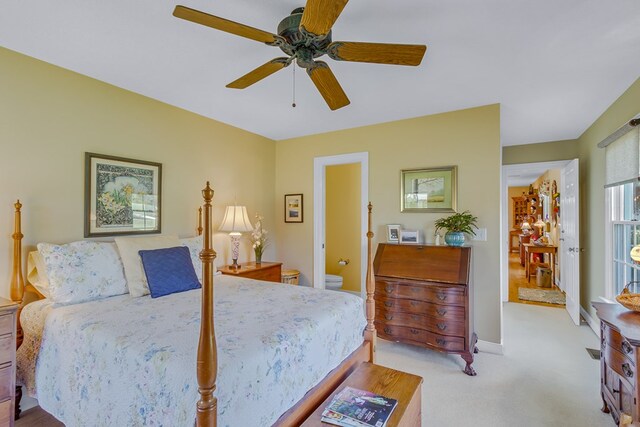bedroom with ceiling fan, light colored carpet, and baseboards