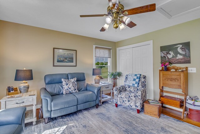 living area featuring a ceiling fan and wood finished floors