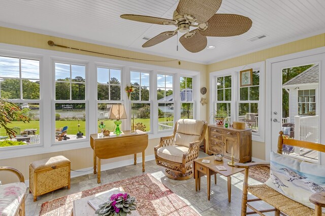 sunroom with stone finish floor, french doors, baseboards, visible vents, and ornamental molding