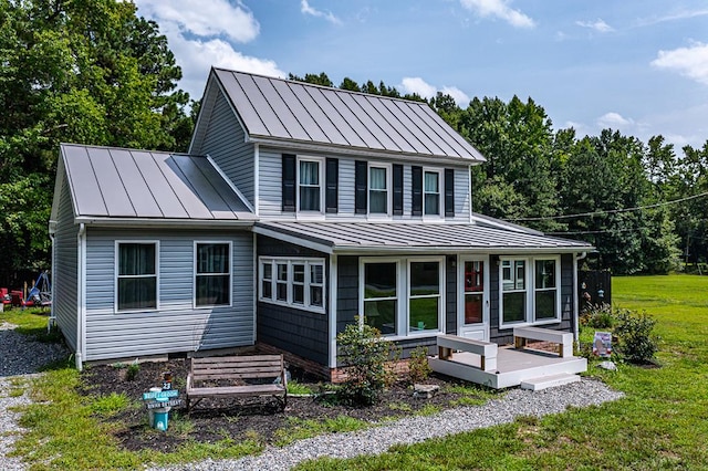 rear view of house featuring a yard