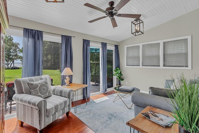 sunroom with ceiling fan, wood ceiling, and vaulted ceiling