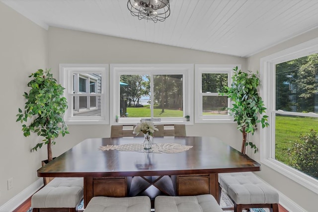 dining space featuring an inviting chandelier, hardwood / wood-style flooring, vaulted ceiling, and wooden ceiling