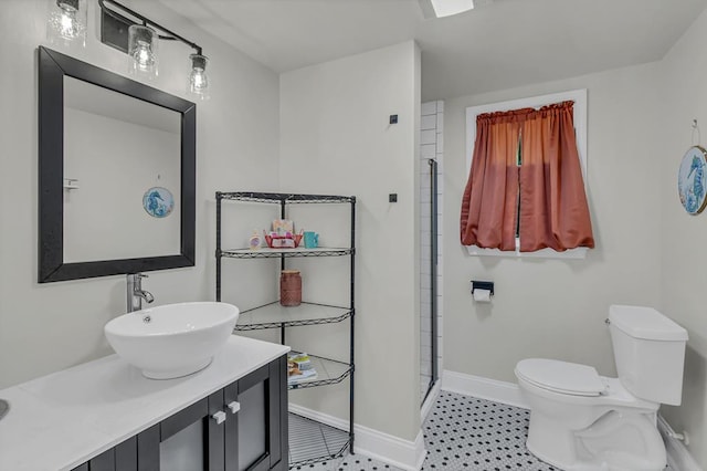 bathroom with vanity, toilet, and a shower with shower door