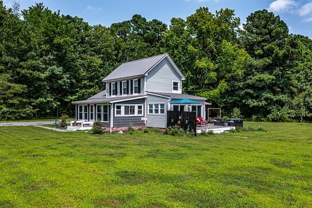 rear view of house featuring a patio and a lawn