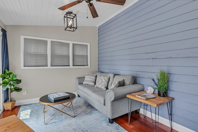 living room with ceiling fan, hardwood / wood-style floors, lofted ceiling, wooden walls, and wood ceiling