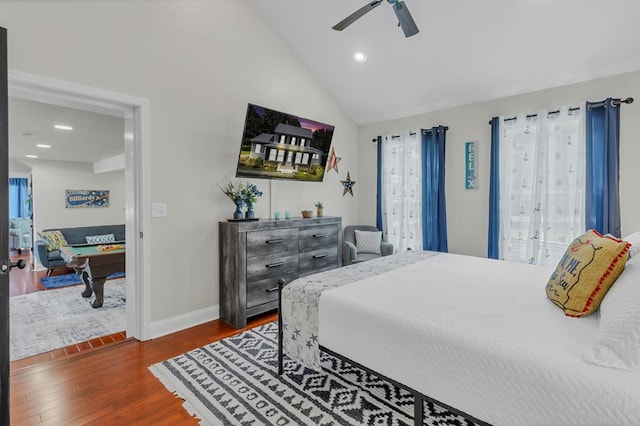 bedroom with multiple windows, dark hardwood / wood-style floors, ceiling fan, and lofted ceiling