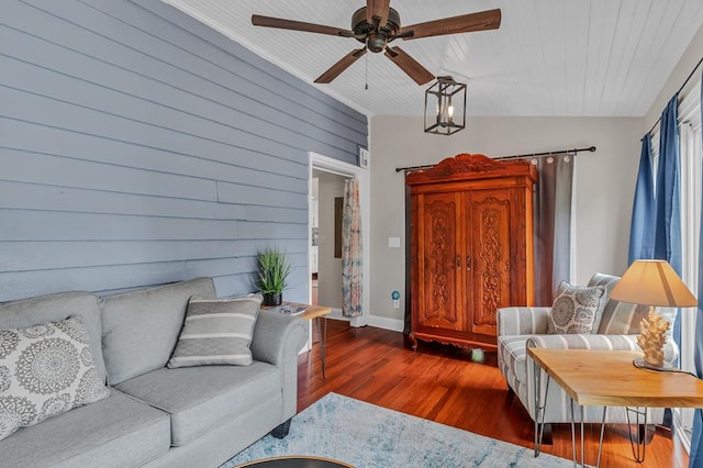 living room featuring dark hardwood / wood-style flooring, ceiling fan, and wood walls