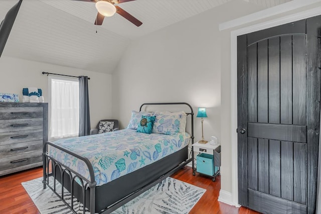 bedroom featuring hardwood / wood-style flooring, vaulted ceiling, and ceiling fan