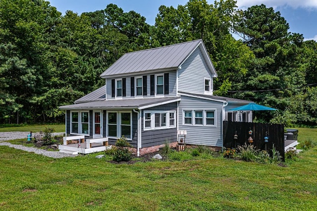 back of house featuring a lawn