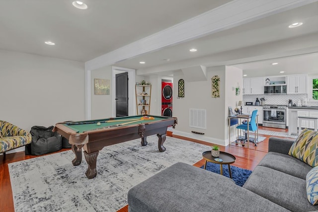 recreation room with beam ceiling, pool table, and light hardwood / wood-style flooring