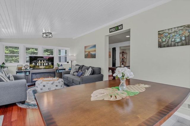 dining area with a wealth of natural light, wood-type flooring, and wooden ceiling