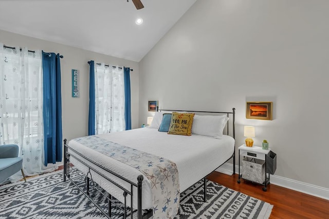 bedroom with vaulted ceiling, ceiling fan, and dark wood-type flooring